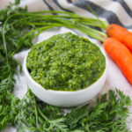side close view of bowl of carrot top pesto