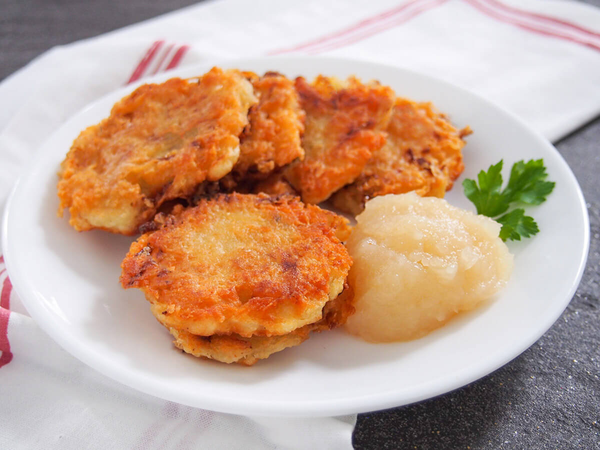 plate of German potato pancakes with apple sauce on side of plate