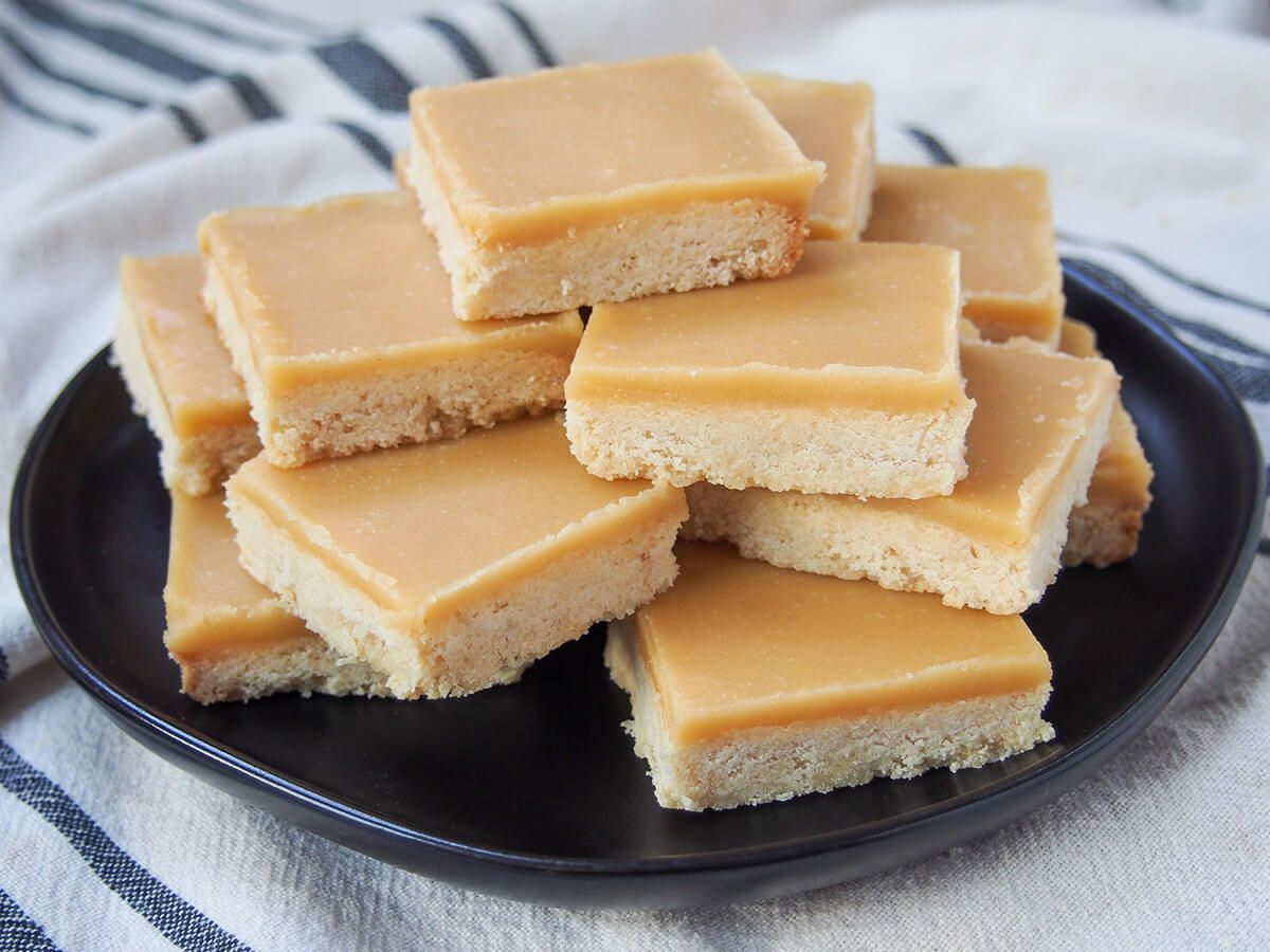 plate with squares of ginger crunch slice stacked on it