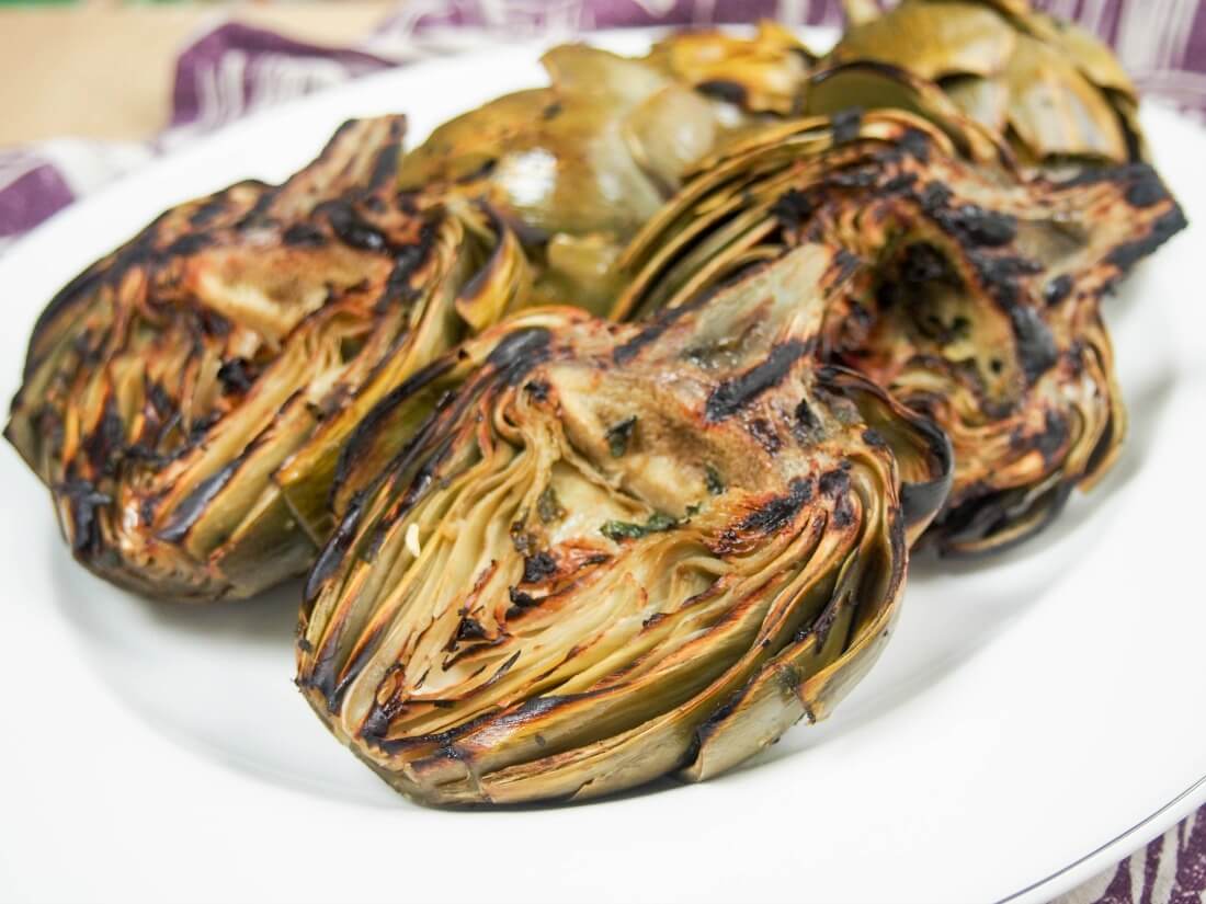 plate of grilled artichokes from side