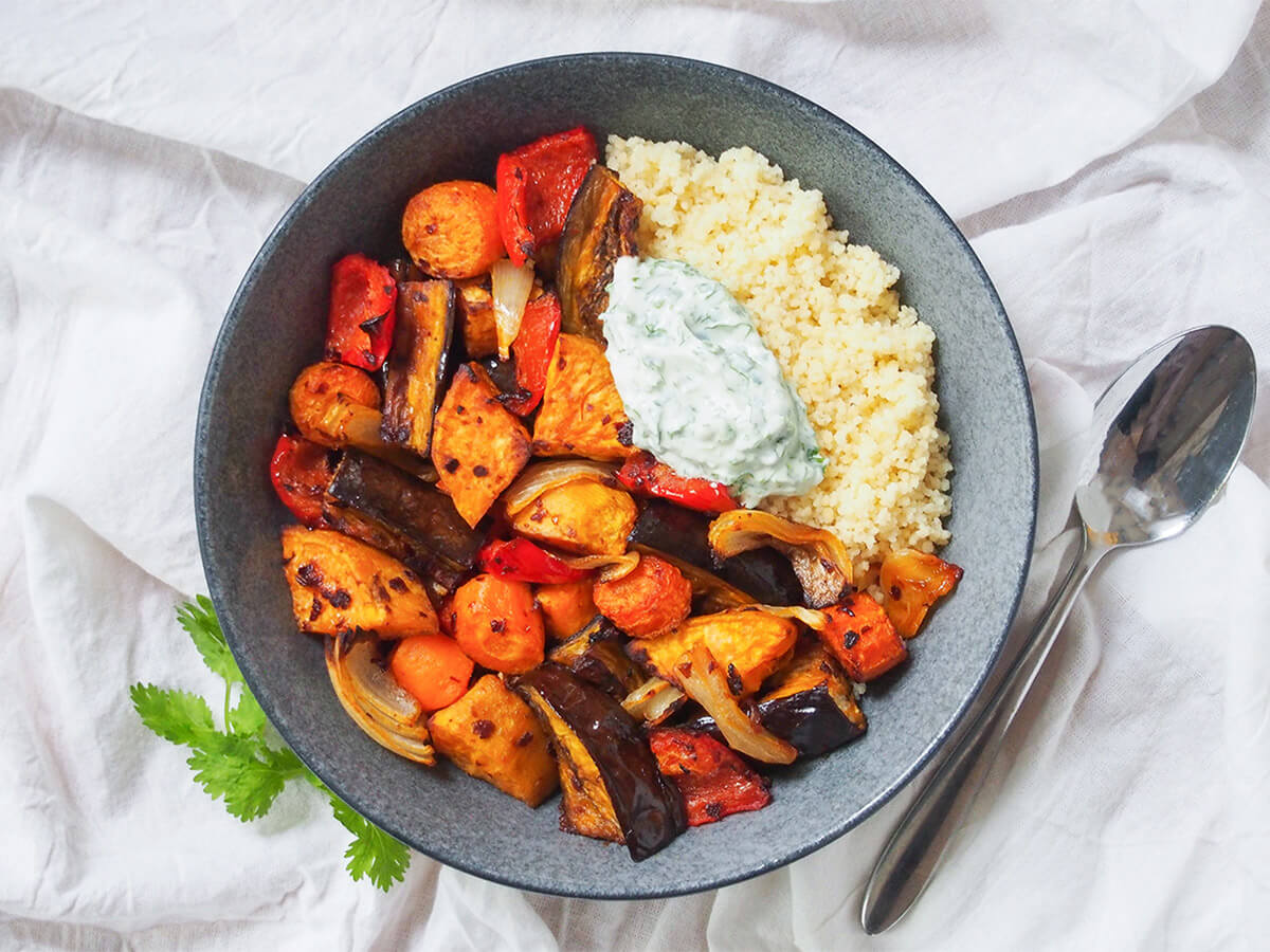 bowl of harissa roasted vegetables with spoon to side.