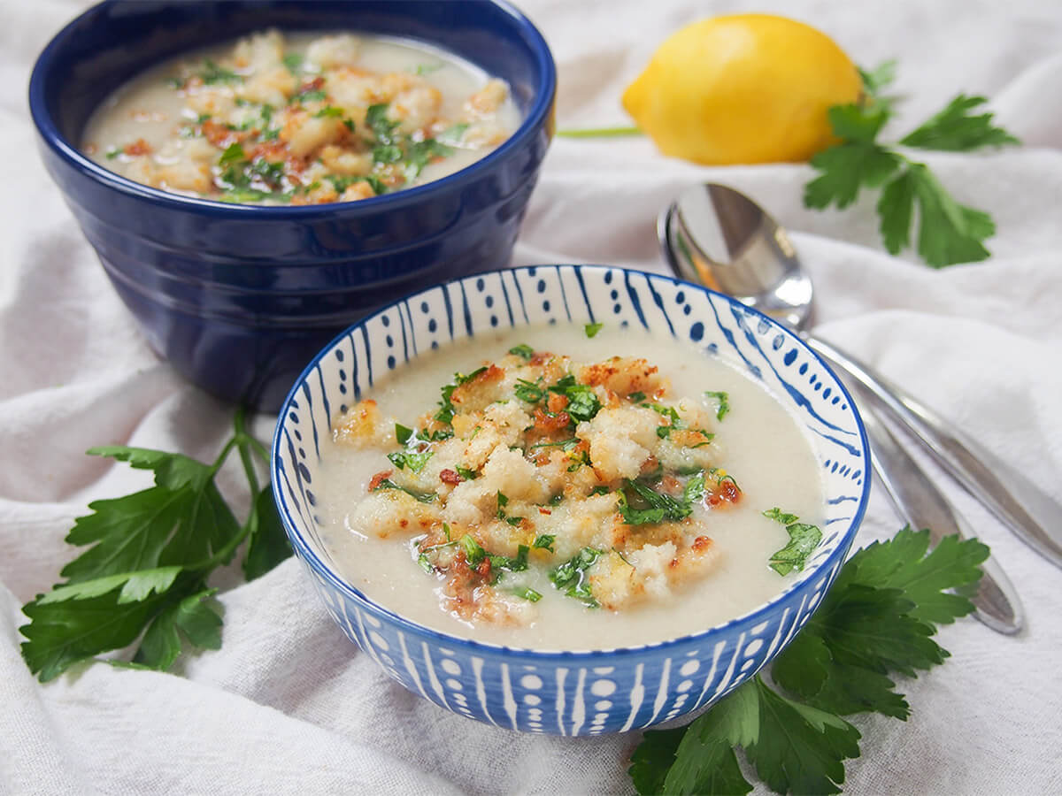 bowl of Jerusalem artichoke soup with second bowl and. lemon behind