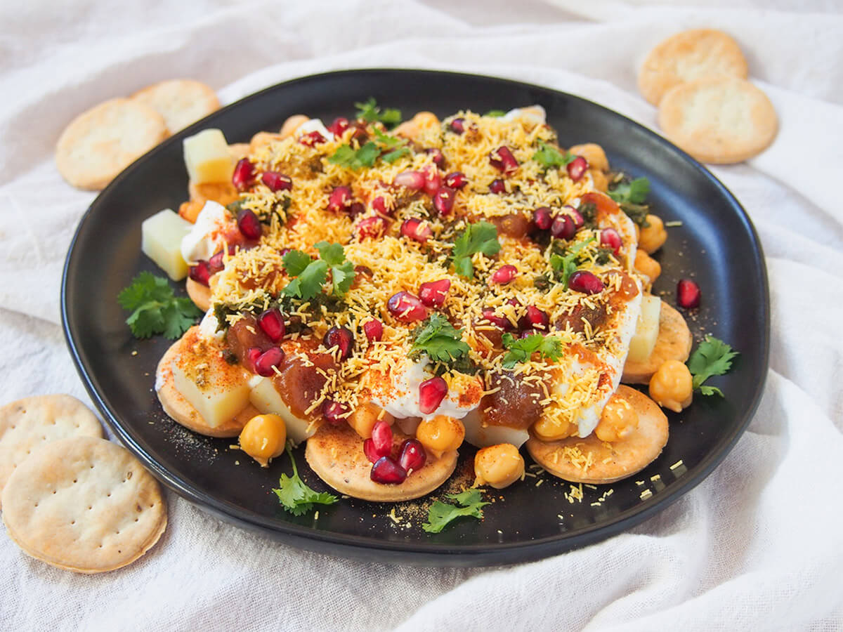 plate of papdi chaat with crackers to side