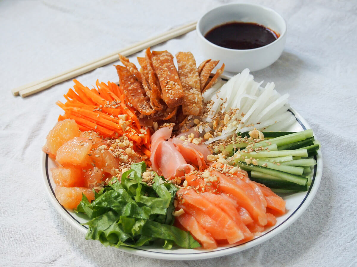 plate of yee sang prosperity toss with chopsticks behind.